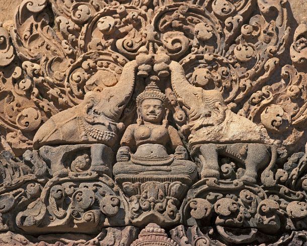 sm_banteisreigN1397 The Hindu goddess, Lakshmi, flanked by elephants, showering her with water, bas-relief of fronton at Banteay Srei temple, Citadel of the Women, Angkor, Cambodia