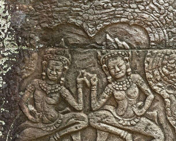 sm_bayonN1436 Two dancing Apsaras framed by intricate and intertwined leaf patterns, Bas-relief carved in stone, Bayon temple, Angkor Thom, Siem Reap, Cambodia