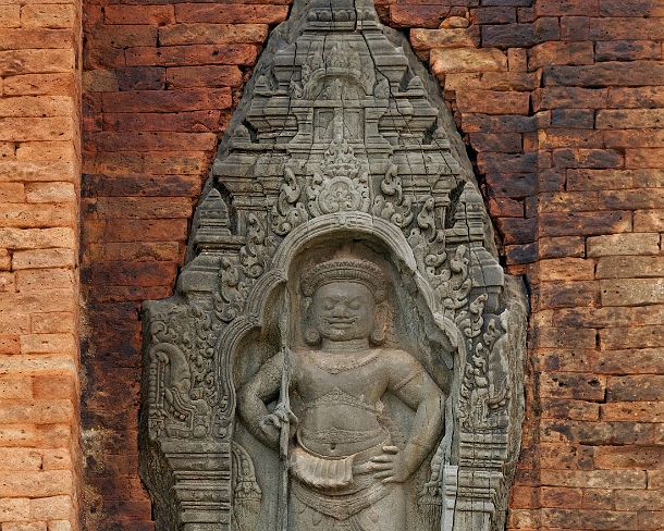 sm_loleiN1452 Bas-relief of a male guardian (Dvarapala in Sanskrit) holding a trident, Lolei temple, built by King Yasovarman I in 9th century, Rolous group. Angkor, Cambodia