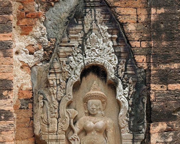 sm_loleiN1453 Bas-relief of a female divinity wearing a beautiful long pleated garment and holding a fly whisk, Lolei temple, built by King Yasovarman I in 9th century,...