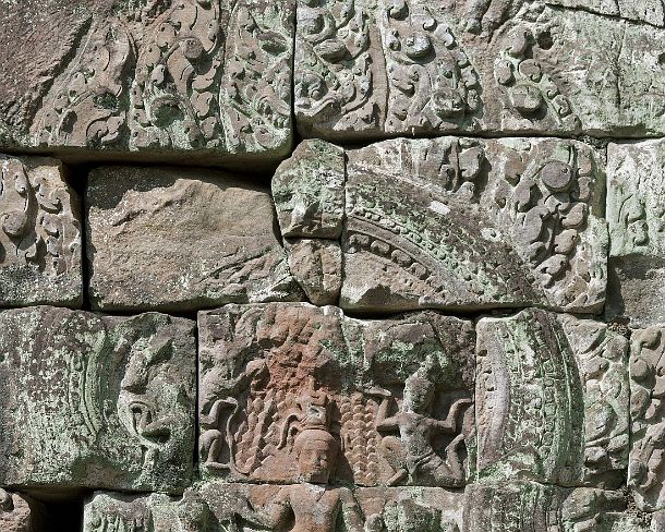 smpreakhanN1459 Wall decorated with bas-reliefs, lower row depicts Hindu wise men or ascetics, also known as essais, sitting cross-legged, Preah Khan temple, built by King...