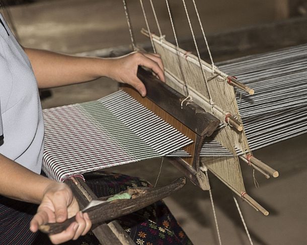 smLuangPN1508 Weaving on a traditional Lao-Thai style loom, Ban Phanom, Laos