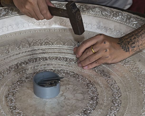 smLuangPN1512 Silversmith engraving a silver bowl with hammer and nails, Ban Phanom, Laos