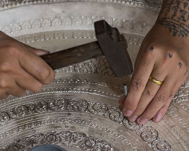 smLuangPN1513 Silversmith engraving a silver bowl with hammer and nails, Ban Phanom, Laos