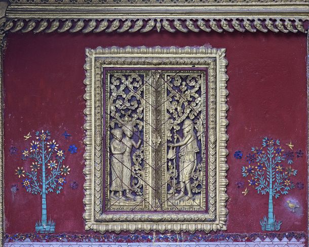 smLuangPtemplesN1570 Carved blind window flanked by glass mosaic trees, Temple Wat Souvannakhirii, Luang Prabang, Laos