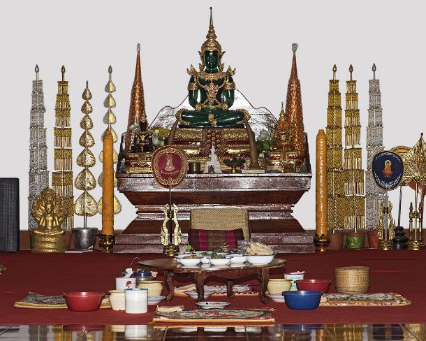 smLuangPtemplesN1589 Lunch table dressed with alms collected in the morning in front of an altar with a replica of the Emerald Buddha in meditation mudra, Temple Wat Nong...