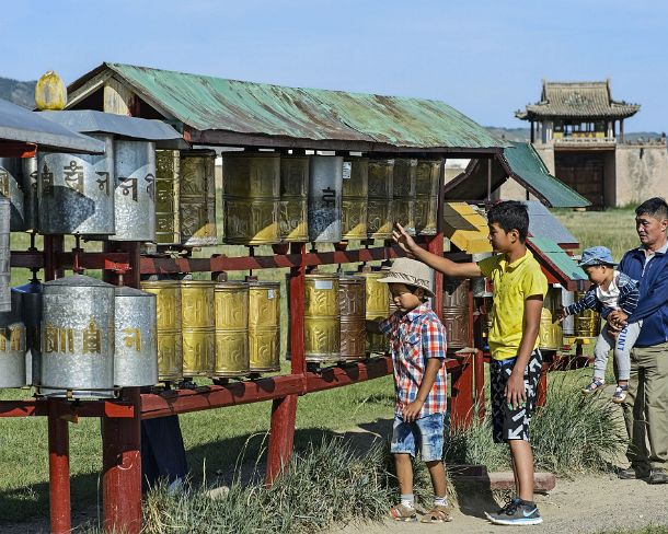 smMongolN1660 Mongolian visitors are turning prayer wheels in Erdene Zuu monastery, the earliest surviving Buddhist monastery in Mongolia, located near today's town of...