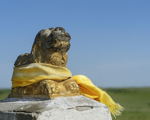 smMongolN1669 Small lion sculptur with yellow silk scarf (khata) at Erdene Zuu monastery, the earliest surviving Buddhist monastery in Mongolia, located near today's town of...
